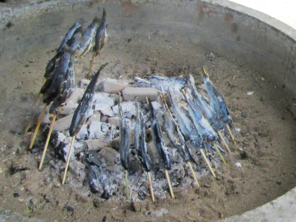 囲炉裏で焼かれる大量の川魚